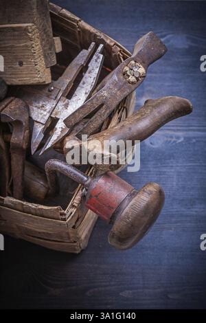 Group of vintage messy tools in wicker box construction concept Stock Photo