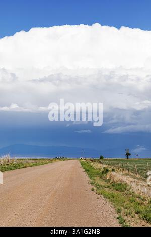Stormy skiy down a long dirt road in rural Colorado, USA Stock Photo