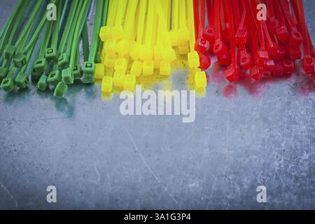 Heap of plastic cable ties on metallic background Stock Photo