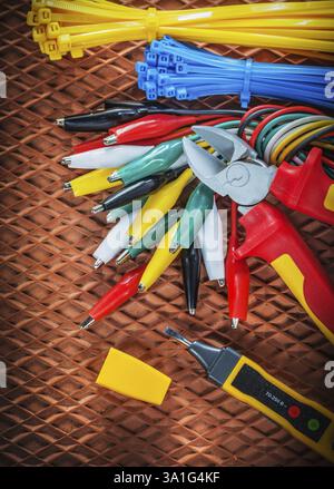Insulation wire cutter tying cables electrical tester crocodile plugs on dielectric mat Stock Photo