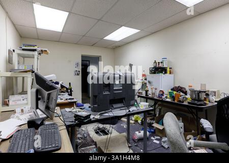A very messy office in an abandoned office building. This building has been demolished Stock Photo