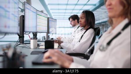 Multiracial Medical Team Manages Billing Codes Using Online Spreadsheets Stock Photo