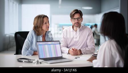Smiling Attractive African American Couple Expecting Baby Meet with Doctor Stock Photo