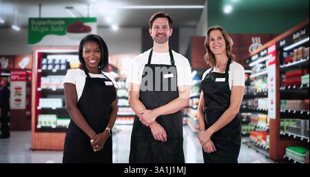 Diverse team of supermarket staff manage store with executive manager. Stock Photo