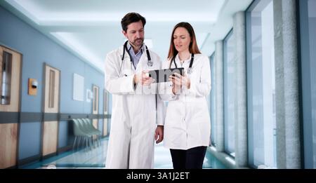 Doctors consult in hospital, discussing patient cases and treatment options. Stock Photo