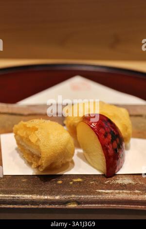 Japanese cuisine: anago (conger eel) tempura with baked apple in Tokyo, Japan Stock Photo