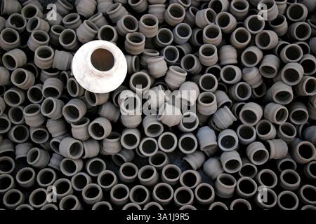 White raw earthen water pot kept on several other small pots after making, Pune, Maharashtra, India, Asia Stock Photo