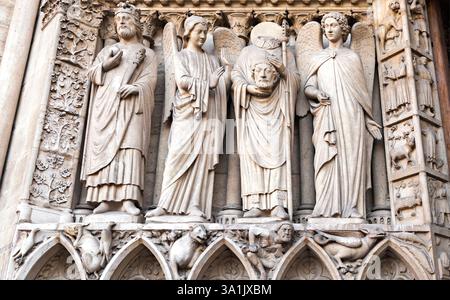 Stone sculptures represent biblical characters, featuring detailed carvings on at Notre-Dame de Paris, France. Stock Photo