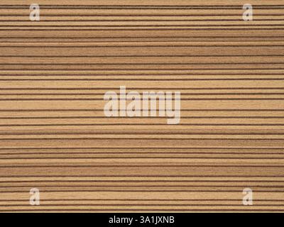Rich golden and caramel tones dance across this Santos Rosewood veneer, creating a luxurious linear landscape Stock Photo