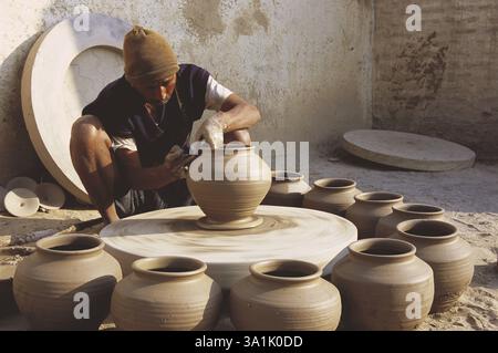 Pottery, potter giving shape to clay pot on wheel, Bikaner, Rajasthan, India, Asia Stock Photo