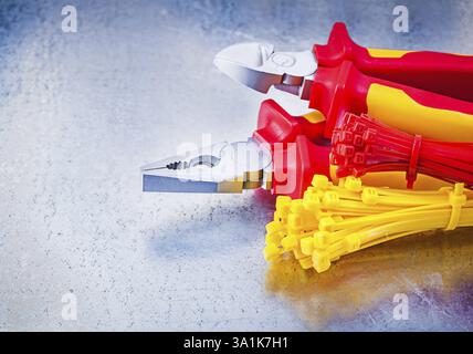 Nippers pliers self-locking cable ties on metallic background construction concept Stock Photo