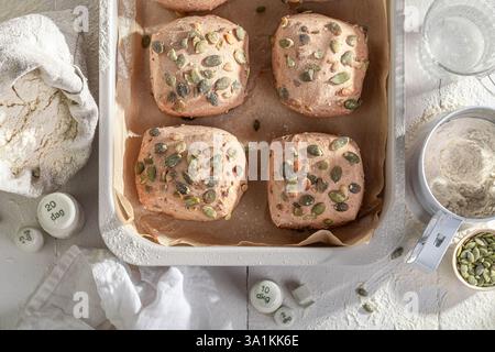 Crisp and golden pumpkin seed rolls straight from the bakehouse. A warm and comforting bread option. Stock Photo
