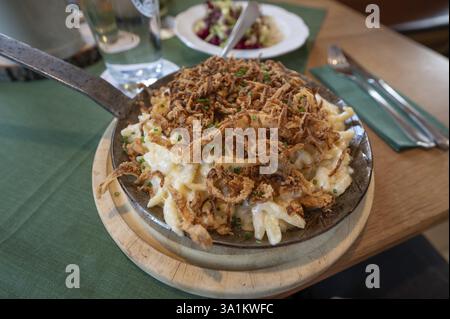 Cheese spaetzle with fried onions served in a small pan in an inn, Franconia, Bavaria, Germany, Europe Stock Photo