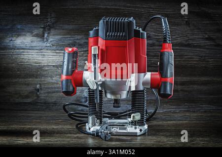 Red speed variable power small plunge router milling machine portable electric hand mini wood router on vintage wood Stock Photo