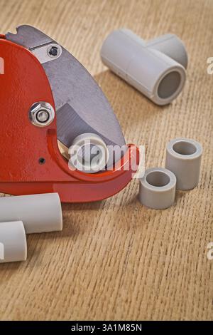 Pipe cutter with cutted pipes on wooden boards close up Stock Photo