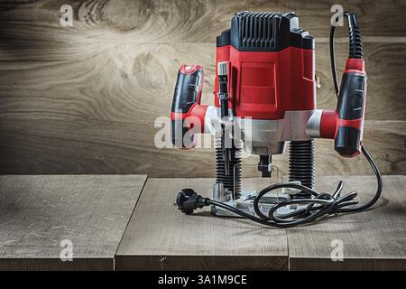 Red speed variable power small plunge router milling machine portable electric hand mini wood router on vintage wooden background Stock Photo