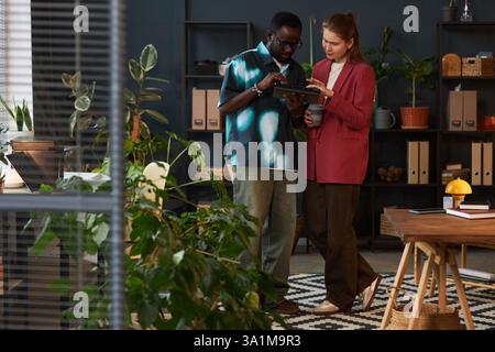 Colleagues Working Together In Eco Office Stock Photo