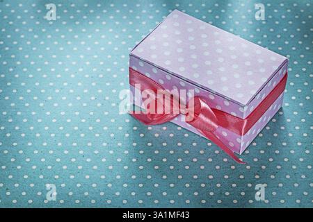 Pink gift box on blue polka-dot background holidays concept Stock Photo