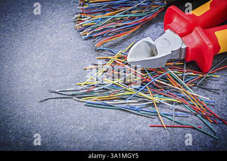 Multicolored electric cables wire cutter on black background electricity concept Stock Photo