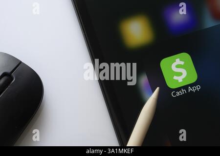 A close up of an iPad screen displaying the Cash App Stock Photo
