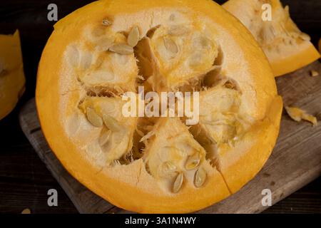 one pumpkin with seeds cut into pieces, details of the pumpkin part with soft sweet flesh and large seeds Stock Photo