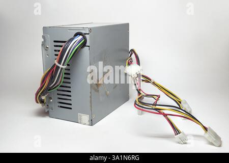 computer ATX power supply unit front side with ventilation openings. colorful power cords for conneting to drives directly from non-modular case Stock Photo