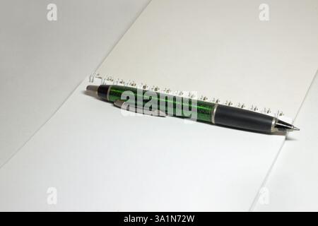 blank flip notepad on binding spring, big nice spring pen on white unlined clear pages Stock Photo