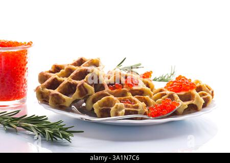 Potato waffles with red caviar on a white background. Stock Photo
