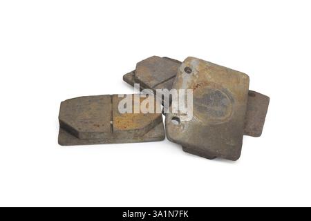 heavily worn broken brake pads of car. with clipping path Stock Photo