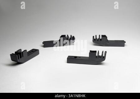 windshield wiper blade arm adapters neatly laid out on white background Stock Photo