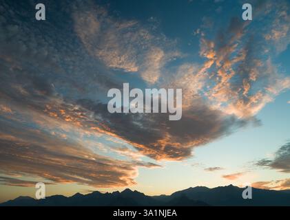 Dramatic sunset or sunrise time dramatic sky over mountain ranges Stock Photo