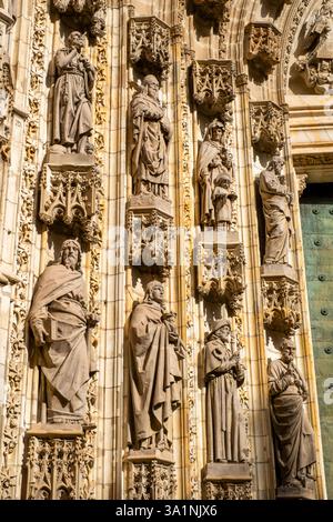 Stone figures around the Door of Assumption, centre of the west facade of the Cathedral of Saint Mary of the See. (Seville Cathedral) Seville, Spain Stock Photo
