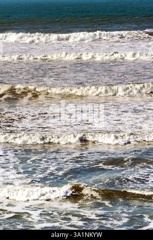 Waves rolling onto a beach. No people. Stock Photo