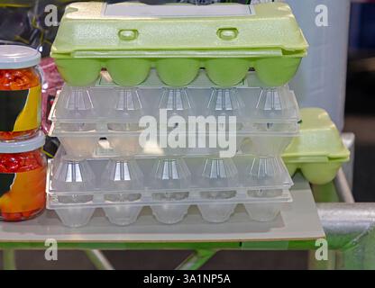 Empty eggs cartons sold outside on market stall Stock Photo