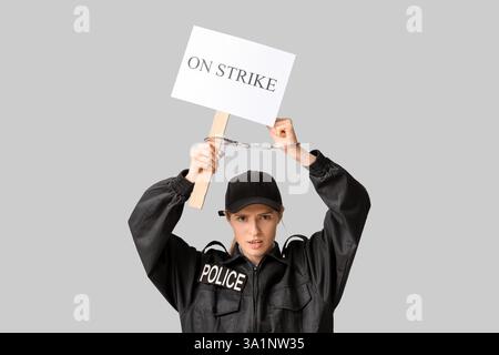 Young police officer holding handcuffs Stock Photo - Alamy