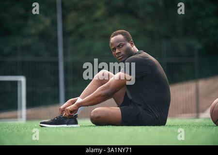 Handsome black man is posing outdoors at daytime. Stock Photo