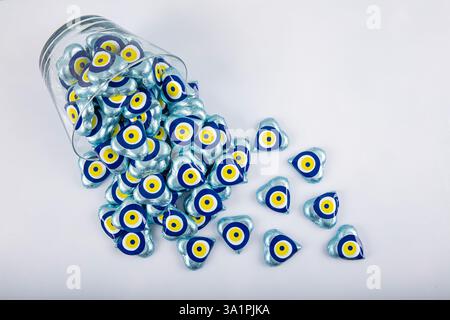 Chocolate with heart shaped evil eye beads covered with aluminum foil. Heart shaped chocolates wrapped in aluminum foil to be given as gifts on Valent Stock Photo