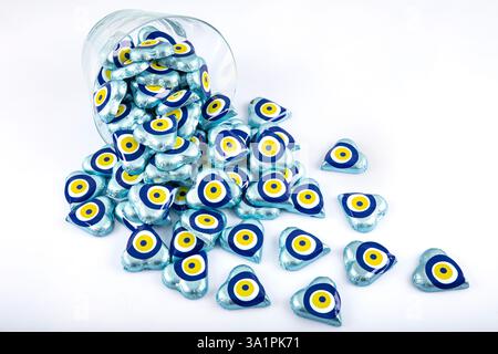 Chocolate with heart shaped evil eye beads covered with aluminum foil. Heart shaped chocolates wrapped in aluminum foil to be given as gifts on Valent Stock Photo