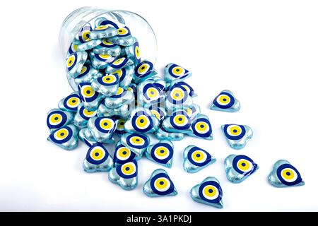 Chocolate with heart shaped evil eye beads covered with aluminum foil. Heart shaped chocolates wrapped in aluminum foil to be given as gifts on Valent Stock Photo