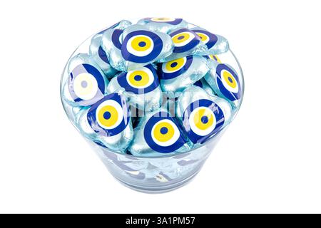 Chocolate with heart shaped evil eye beads covered with aluminum foil. Heart shaped chocolates wrapped in aluminum foil to be given as gifts on Valent Stock Photo