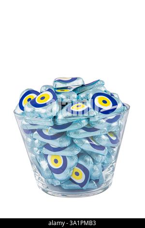 Chocolate with heart shaped evil eye beads covered with aluminum foil. Heart shaped chocolates wrapped in aluminum foil to be given as gifts on Valent Stock Photo