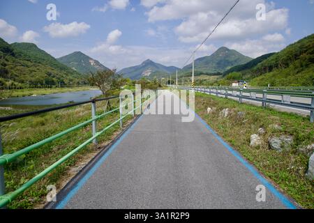 Sunchang County, South Korea - October 4, 2021: A well-maintained section of the Seomjingang Bike Path follows the Seomjin River, with green railings Stock Photo