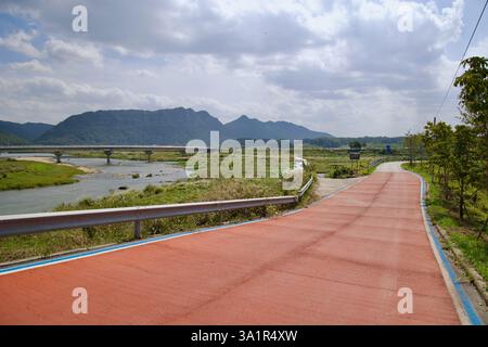 Sunchang County, South Korea - October 4, 2021: A section of the Seomjingang Bike Path, marked with a red surface, follows the Seomjin River, leading Stock Photo