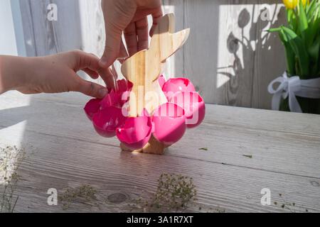 Unrecognizable woman creating Easter holiday decoration from sustainable materials egg shell. Diy do it yourself step by step instruction. Gift present idea Crafting preparation holiday Stock Photo