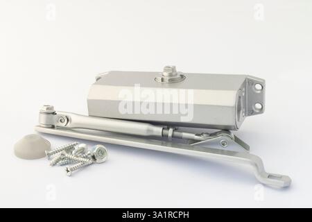 Door Closer Machine with Screws and Mounting Accessories on White Background Stock Photo