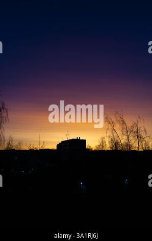 Sunset in the city. The gradient of colors from yellow to purple Stock Photo
