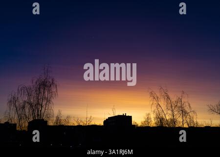 Sunset in the city. The gradient of colors from yellow to purple Stock Photo