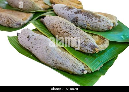 Die cut of Old honeycomb onDie cut of Old honeycomb on the banana leaf on white isolated. the banana leaf on white isolated. Stock Photo