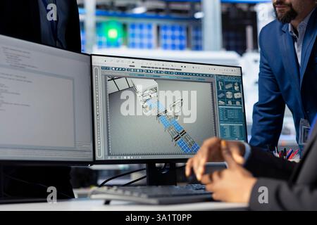 Solar panel manufacturing plant manager checking progress done by technician programming industrial systems developing tools to track and improve equipment performance, close up Stock Photo