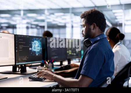 Artificial intelligence engineer in data center checks for performance issues arising due to high CPU usage. Machine learning expert in server farm fixing insufficient memory errors slowing hardware Stock Photo